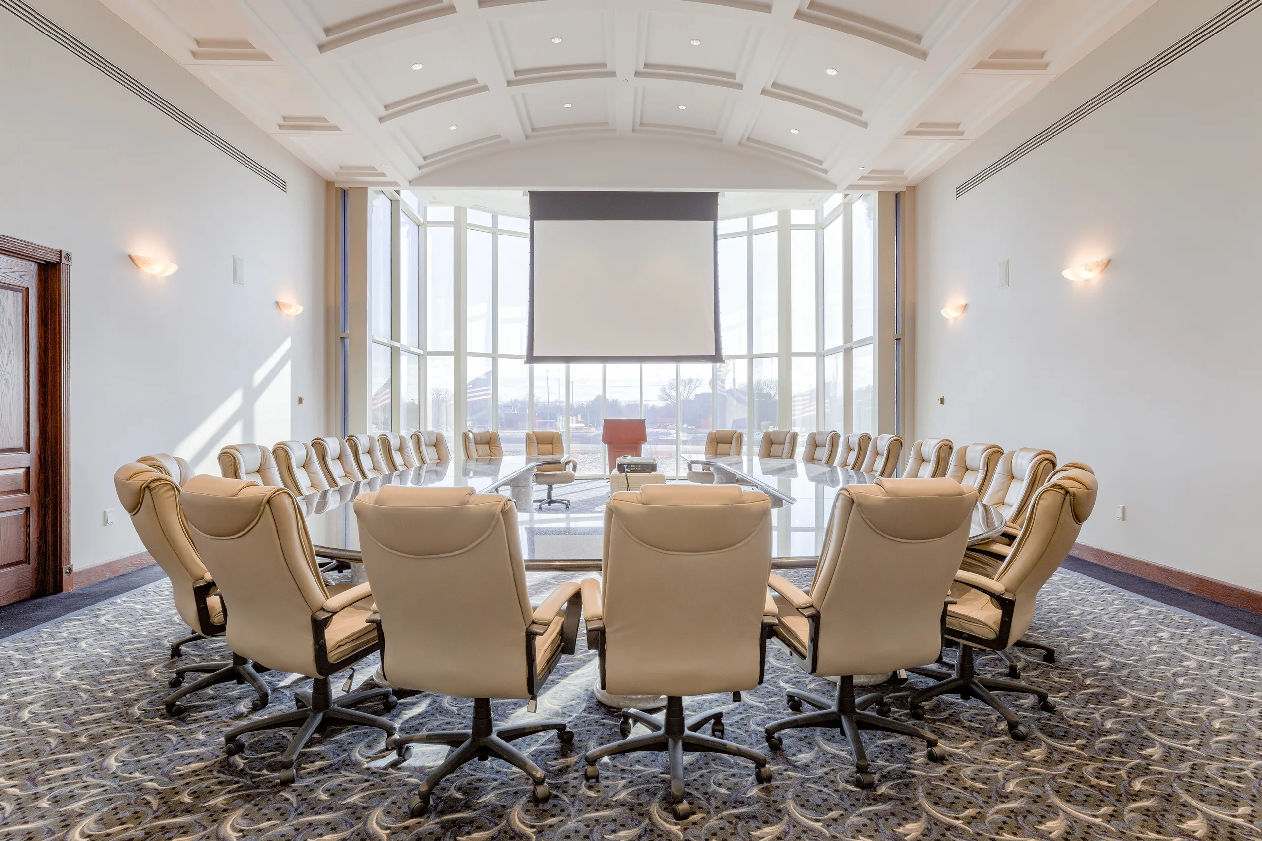 Executive board room at Millennium Plaza with vaulted ceiling and conference table for twenty.