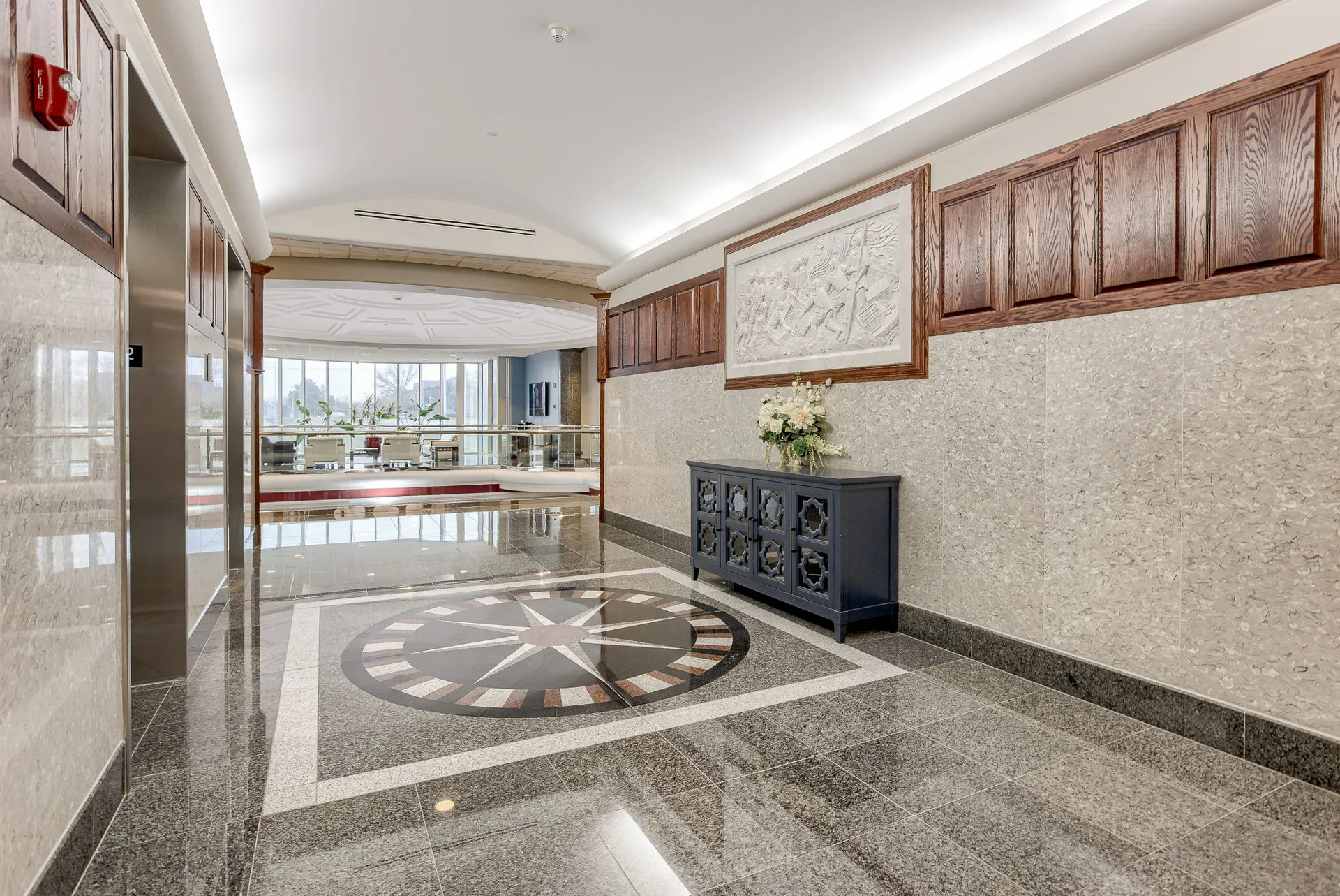 Hand-carved marble compass medallion inlaid in the Millennium Plaza lobby floor.