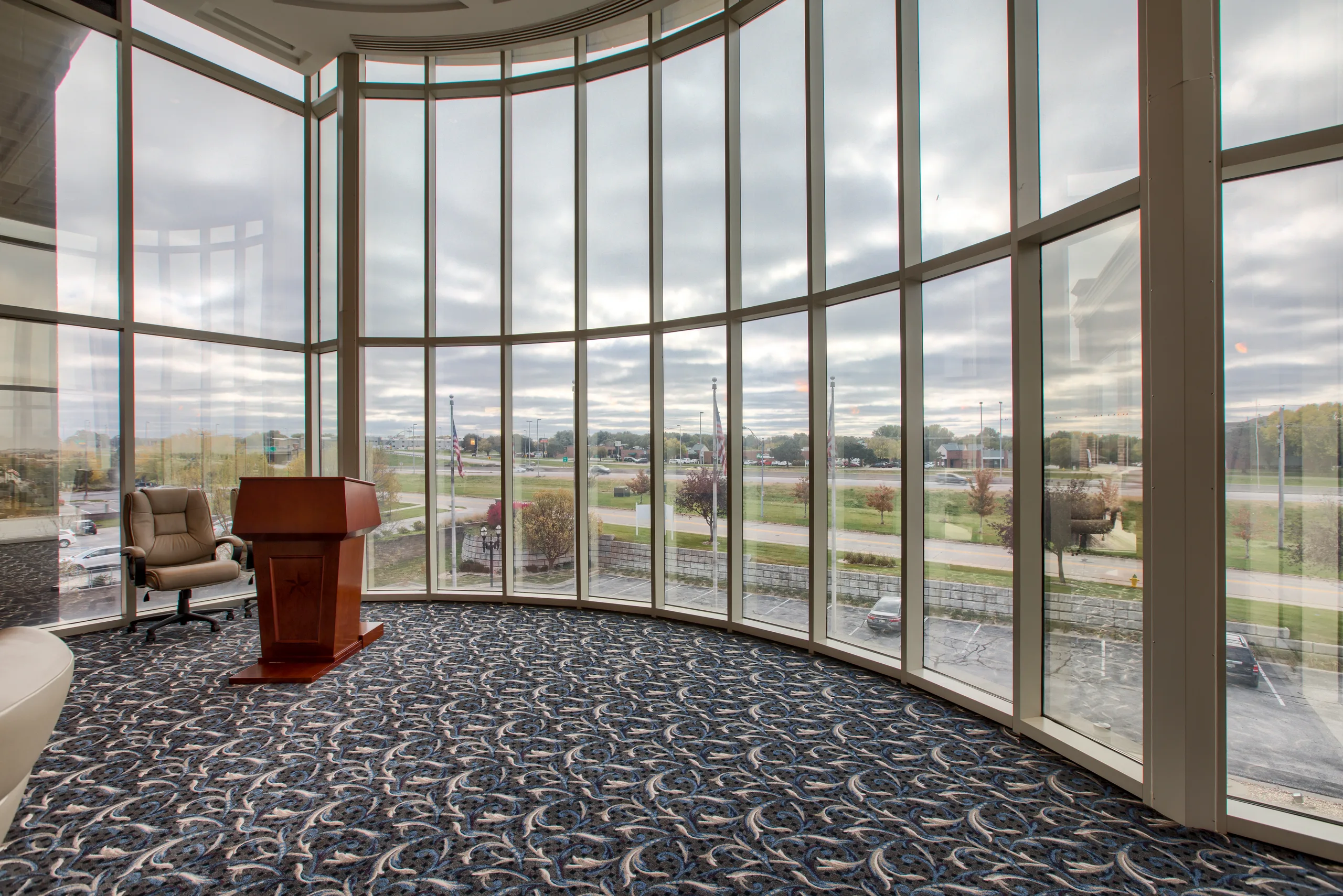 Presentation podium at the front of the executive board room.