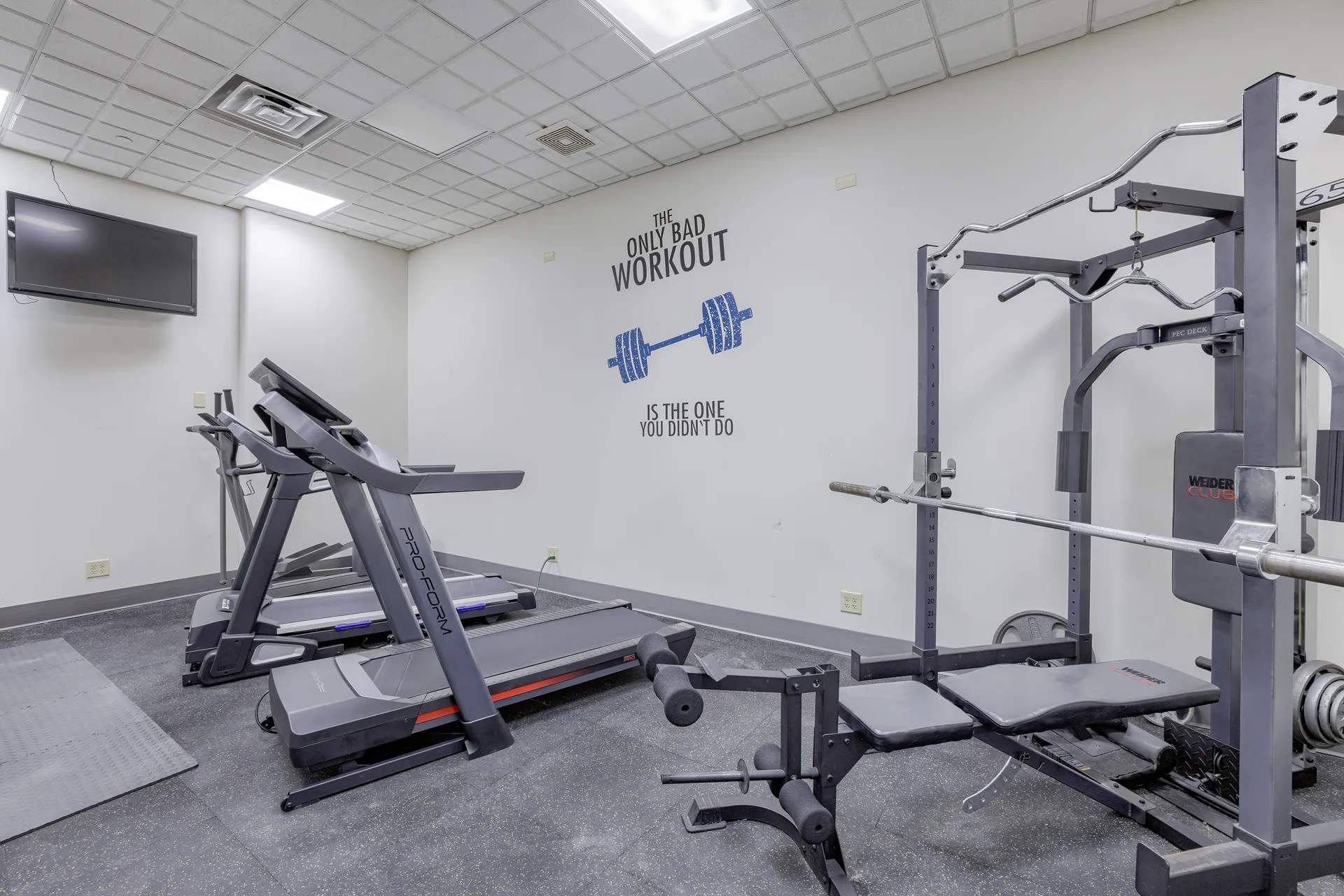 On-site fitness center at Millennium Plaza with treadmills and weight equipment.