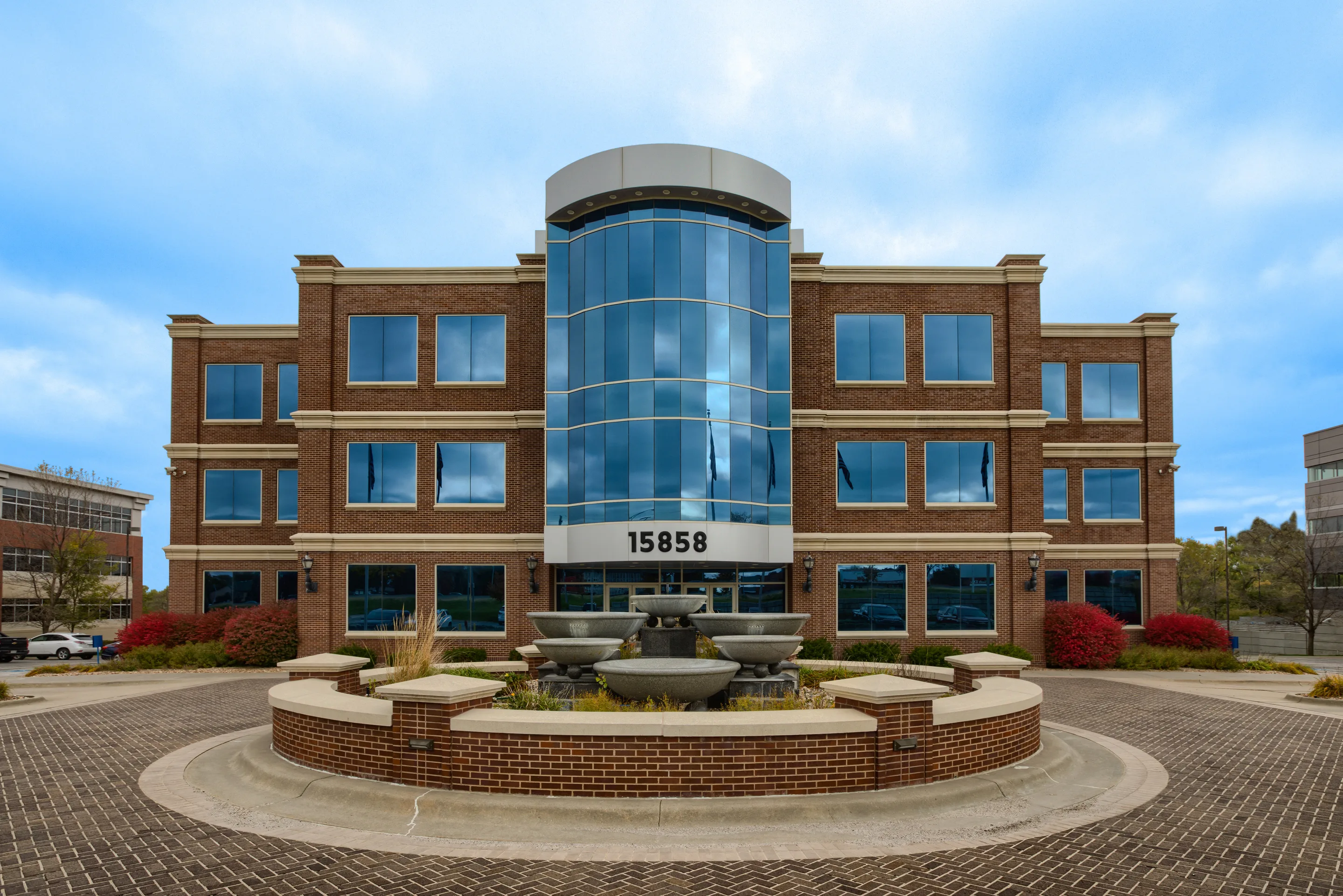 Millennium Plaza, the three-story Class A facade at dusk on West Dodge Road, Omaha.