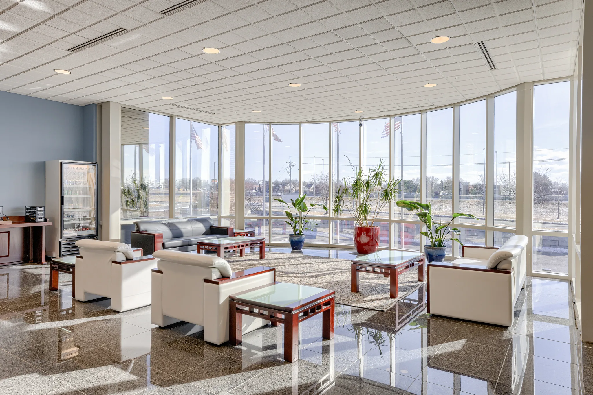 Lobby lounge seating at Millennium Plaza, with granite flooring and marble wall panels.